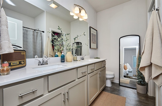 16621 Goodman Dr, Urbandale, IA 50323 - full bathroom with double vanity and wood finished floors