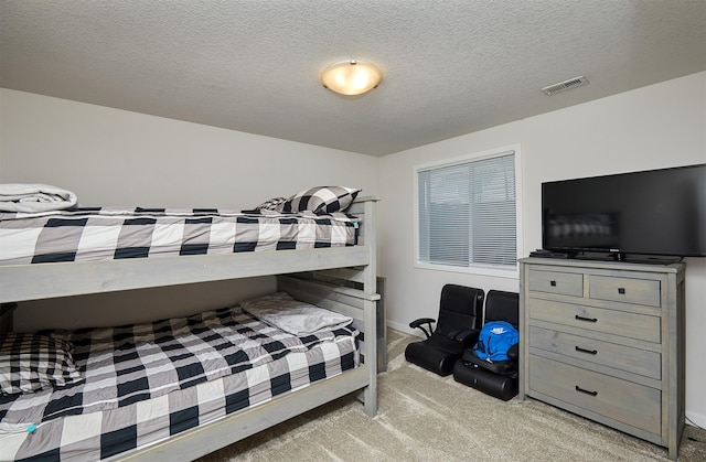 16621 Goodman Dr, Urbandale, IA 50323 - bedroom featuring light carpet and a textured ceiling