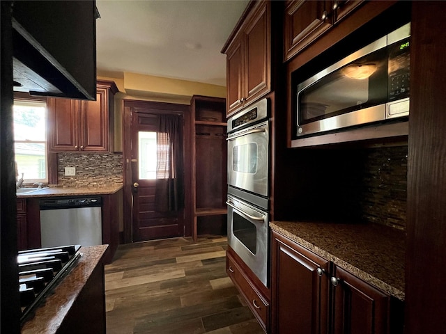 400 W Salem Ave, Indianola, IA 50125 - kitchen with appliances with stainless steel finishes, dark wood-type flooring, tasteful backsplash, and plenty of natural light