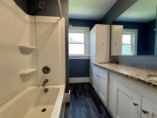 400 W Salem Ave, Indianola, IA 50125 - full bathroom featuring double vanity,  shower combination, and wood finished floors