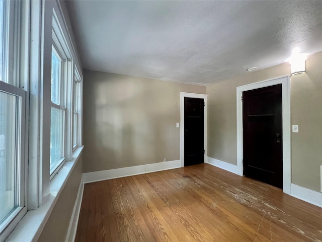 400 W Salem Ave, Indianola, IA 50125 - unfurnished room with wood finished floors, healthy amount of natural light, and a textured ceiling