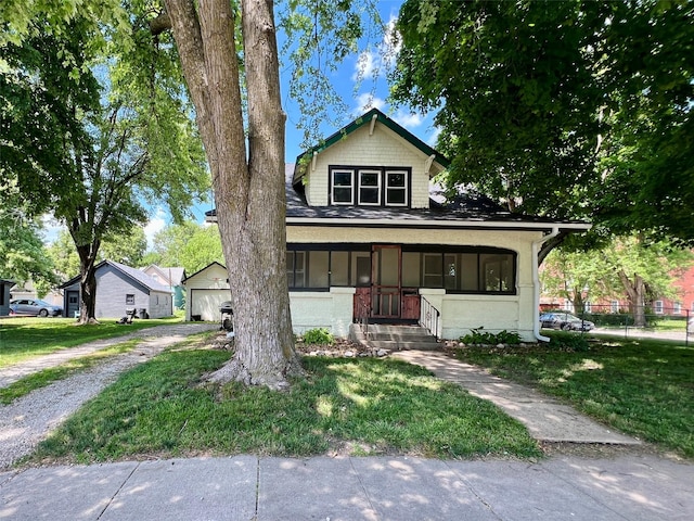 400 W Salem Ave, Indianola, IA 50125 - bungalow-style home featuring a detached garage, gravel driveway, and covered porch