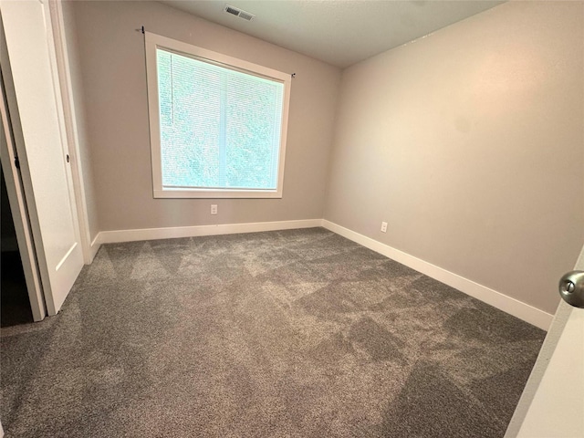 10009 Powell Ave, Johnston, IA 50131 - unfurnished room with dark colored carpet and baseboards
