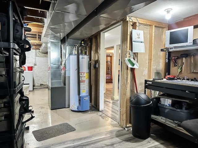 424 Hilltop Rd, Ames, IA 50014 - unfinished basement with gas water heater, heating unit, and washer / dryer