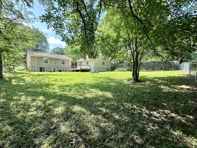 424 Hilltop Rd, Ames, IA 50014 - fenced backyard featuring a wooden deck