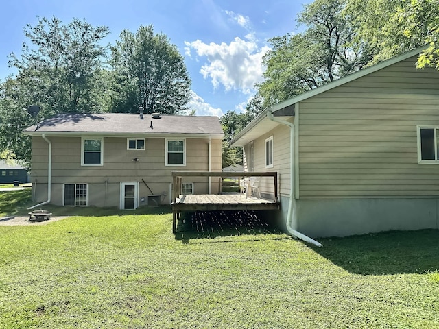 424 Hilltop Rd, Ames, IA 50014 - rear view of house featuring a deck, a yard, and a fire pit