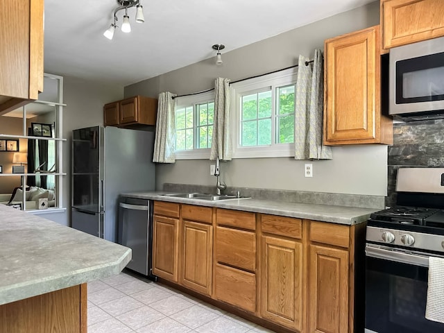 424 Hilltop Rd, Ames, IA 50014 - kitchen featuring appliances with stainless steel finishes, light tile patterned floors, brown cabinets, light countertops, and tasteful backsplash