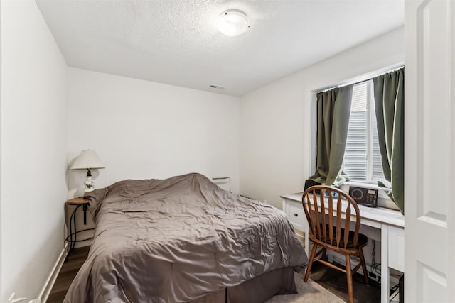 1819 8th Ave SE, Altoona, IA 50009 - bedroom featuring a textured ceiling, an office area, wood finished floors, and multiple windows