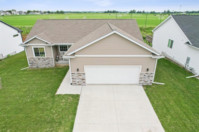 1819 8th Ave SE, Altoona, IA 50009 - view of front of property with stone siding, an attached garage, concrete driveway, and a front lawn