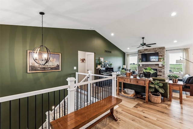 1819 8th Ave SE, Altoona, IA 50009 - living room with light wood-style floors, ceiling fan, a fireplace, recessed lighting, and high vaulted ceiling
