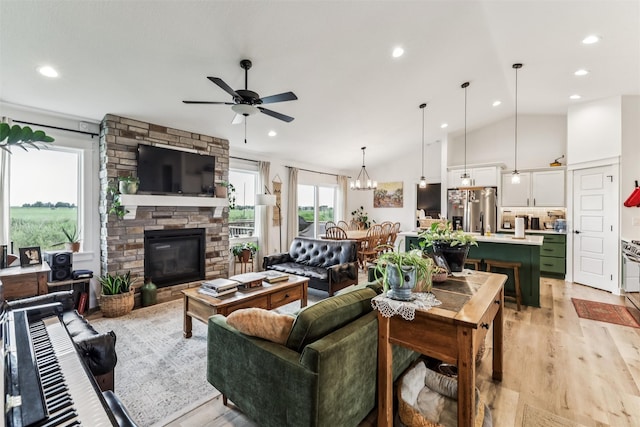 1819 8th Ave SE, Altoona, IA 50009 - living area with a ceiling fan, recessed lighting, a stone fireplace, light wood-style flooring, and vaulted ceiling
