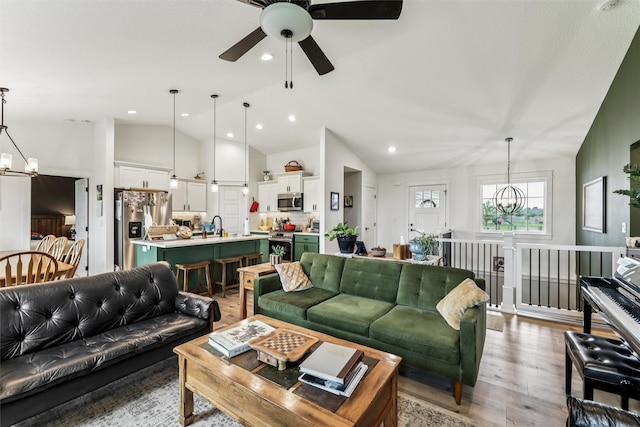 1819 8th Ave SE, Altoona, IA 50009 - living room featuring a chandelier, lofted ceiling, ceiling fan, light wood-style flooring, and recessed lighting