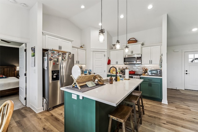 1819 8th Ave SE, Altoona, IA 50009 - kitchen with appliances with stainless steel finishes, light wood-type flooring, decorative backsplash, white cabinets, and high vaulted ceiling