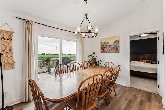 1819 8th Ave SE, Altoona, IA 50009 - dining space featuring a chandelier, wood finished floors, and vaulted ceiling