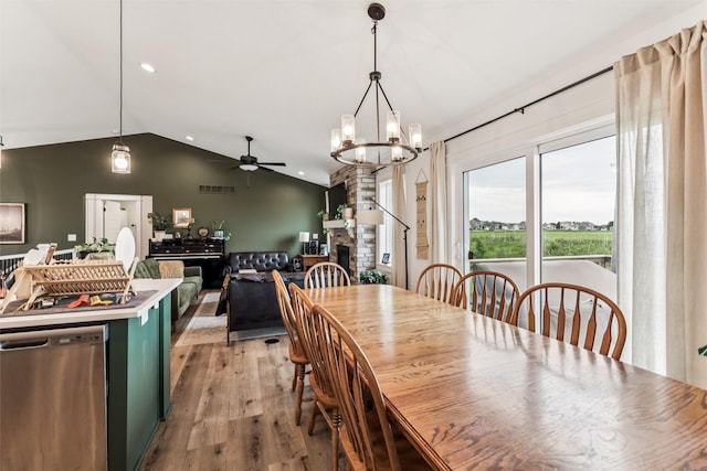 1819 8th Ave SE, Altoona, IA 50009 - dining space featuring lofted ceiling, ceiling fan, light wood-style floors, a chandelier, and a fireplace