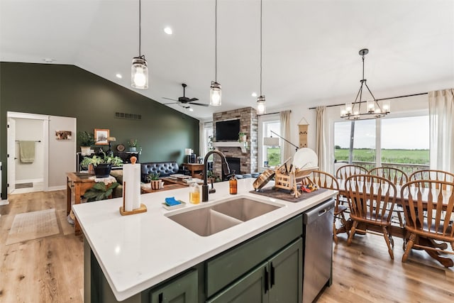 1819 8th Ave SE, Altoona, IA 50009 - kitchen with green cabinets, stainless steel dishwasher, ceiling fan, a fireplace, and vaulted ceiling