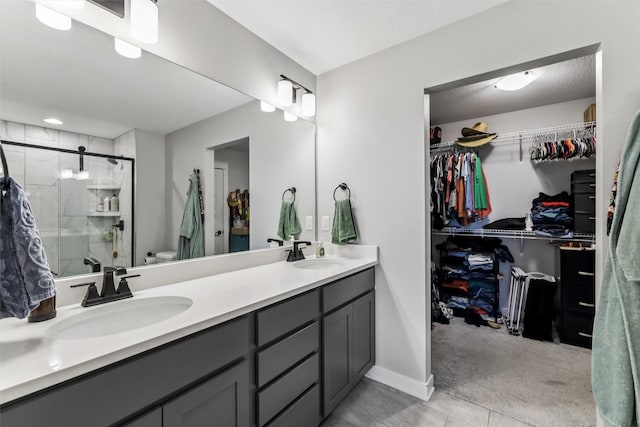 1819 8th Ave SE, Altoona, IA 50009 - full bathroom with double vanity, a shower stall, and a walk in closet