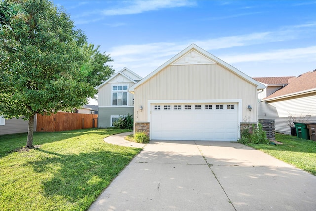900 34th St SW, Bondurant, IA 50035 - view of front of home with stone siding, board and batten siding, driveway, and an attached garage