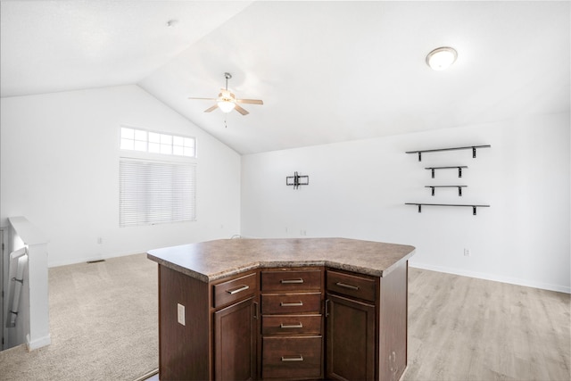 900 34th St SW, Bondurant, IA 50035 - kitchen featuring ceiling fan, vaulted ceiling, a kitchen island, dark brown cabinetry, and open floor plan