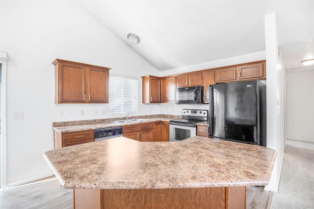 900 34th St SW, Bondurant, IA 50035 - kitchen with black appliances, light countertops, high vaulted ceiling, brown cabinetry, and a center island