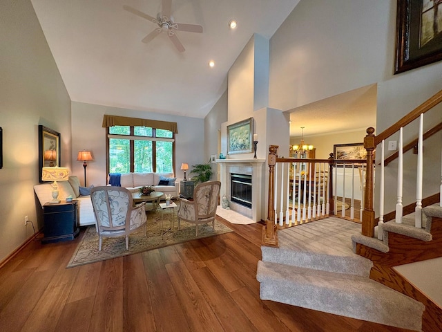 8844 Meredith Dr, Urbandale, IA 50322 - living area featuring high vaulted ceiling, wood finished floors, a chandelier, a ceiling fan, and stairway