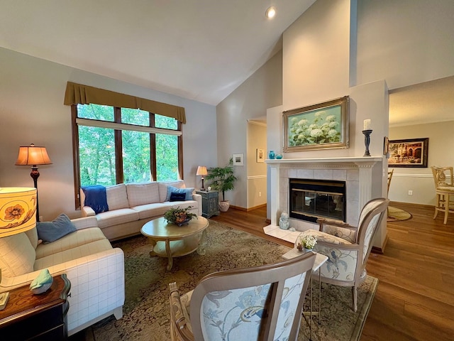 8844 Meredith Dr, Urbandale, IA 50322 - living room featuring high vaulted ceiling, wood finished floors, and a fireplace