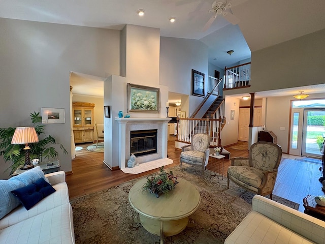 8844 Meredith Dr, Urbandale, IA 50322 - living room with wood finished floors, high vaulted ceiling, stairway, and a fireplace