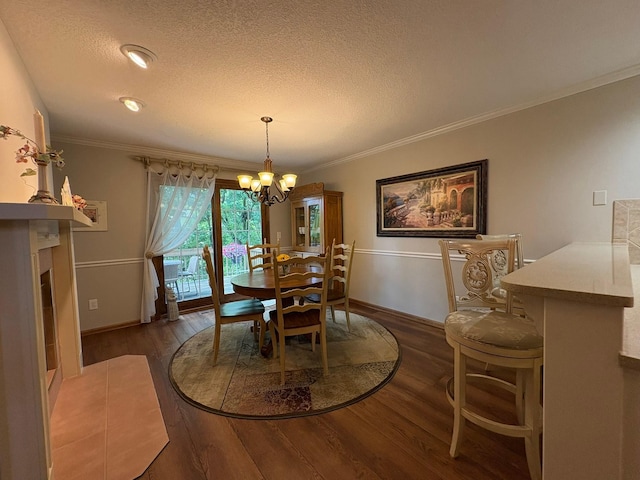 8844 Meredith Dr, Urbandale, IA 50322 - dining room featuring a chandelier, wood finished floors, a textured ceiling, and ornamental molding
