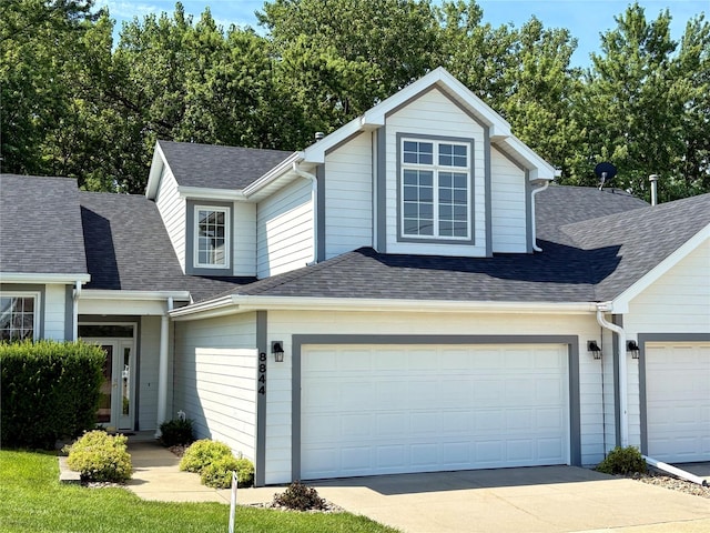 8844 Meredith Dr, Urbandale, IA 50322 - traditional-style house featuring driveway, a shingled roof, and a garage