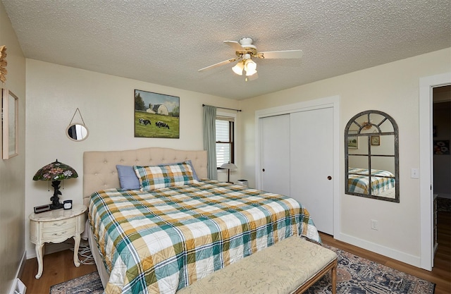 1506 S 14th St, Adel, IA 50003 - bedroom featuring a baseboard radiator, wood finished floors, a closet, a textured ceiling, and a ceiling fan