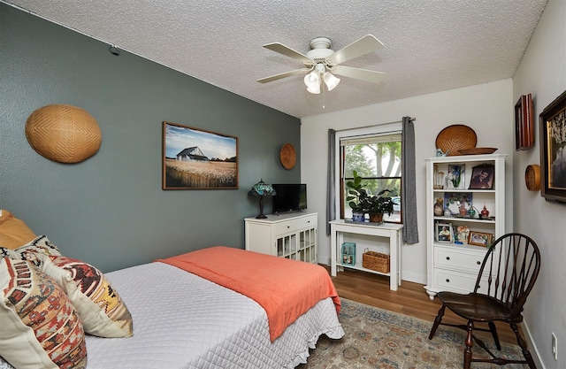 1506 S 14th St, Adel, IA 50003 - bedroom with wood finished floors, a textured ceiling, and a ceiling fan