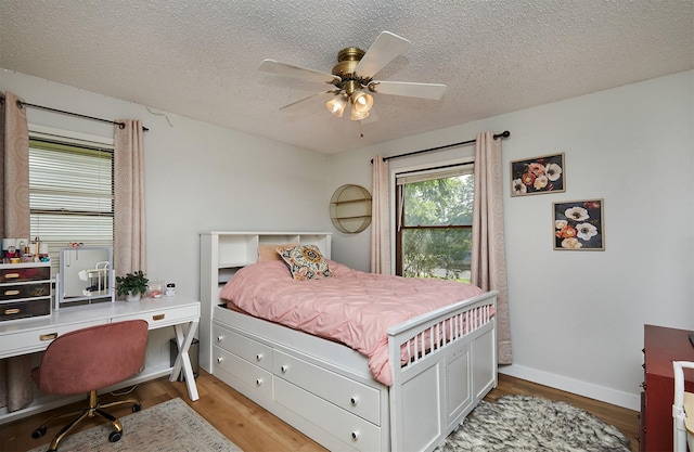 1506 S 14th St, Adel, IA 50003 - bedroom featuring light wood-style floors, a textured ceiling, ceiling fan, and an office area