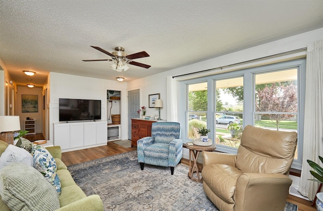 1506 S 14th St, Adel, IA 50003 - living area with wood finished floors, ceiling fan, and a textured ceiling