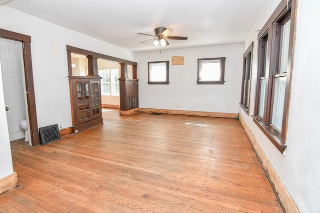 603 W Church St, Marshalltown, IA 50158 - spare room with ceiling fan, light wood-type flooring, and a textured ceiling