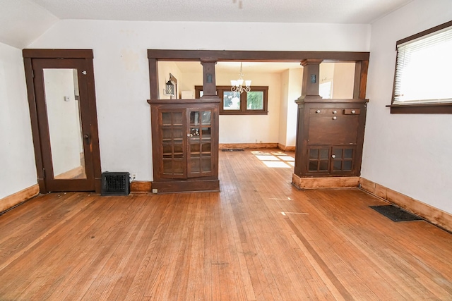 603 W Church St, Marshalltown, IA 50158 - empty room featuring a chandelier and wood-type flooring
