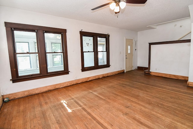 603 W Church St, Marshalltown, IA 50158 - empty room featuring hardwood / wood-style flooring, a ceiling fan, and a textured ceiling