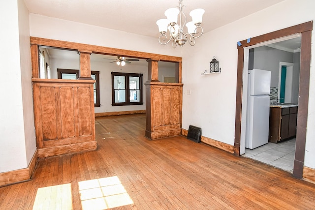 603 W Church St, Marshalltown, IA 50158 - spare room with a ceiling fan, light wood-style floors, and a chandelier