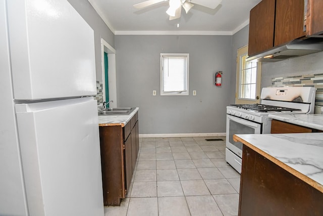 603 W Church St, Marshalltown, IA 50158 - kitchen featuring white appliances, light countertops, a ceiling fan, ornamental molding, and under cabinet range hood