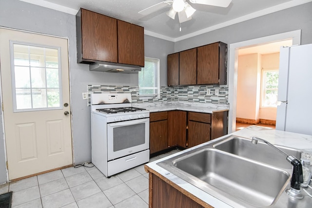 603 W Church St, Marshalltown, IA 50158 - kitchen featuring white appliances, a ceiling fan, light countertops, range hood, and decorative backsplash