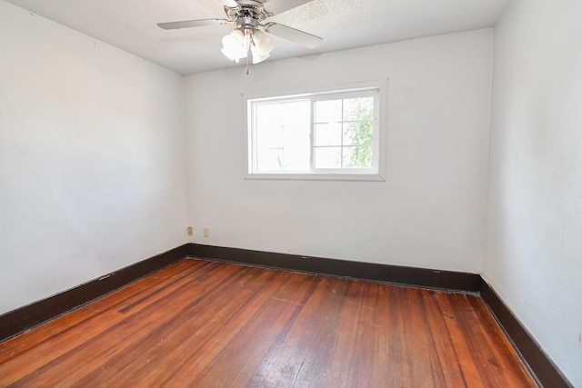 603 W Church St, Marshalltown, IA 50158 - unfurnished room with dark wood-style floors and ceiling fan