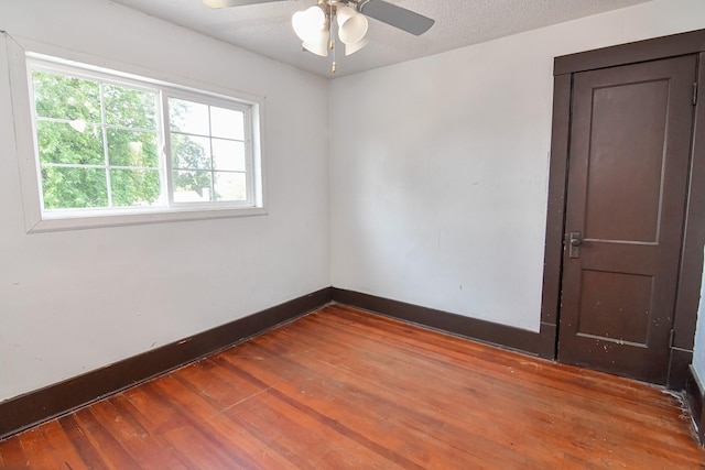 603 W Church St, Marshalltown, IA 50158 - empty room with plenty of natural light, hardwood / wood-style floors, and a ceiling fan