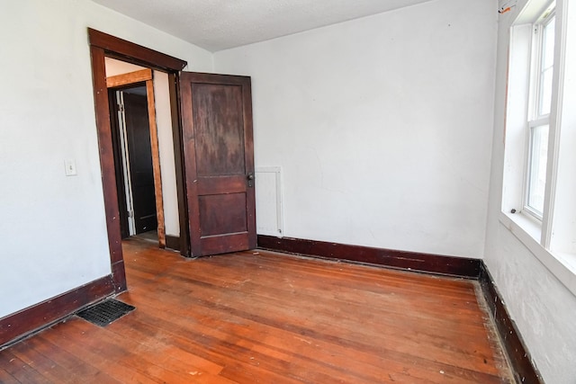 603 W Church St, Marshalltown, IA 50158 - unfurnished room with wood-type flooring and plenty of natural light