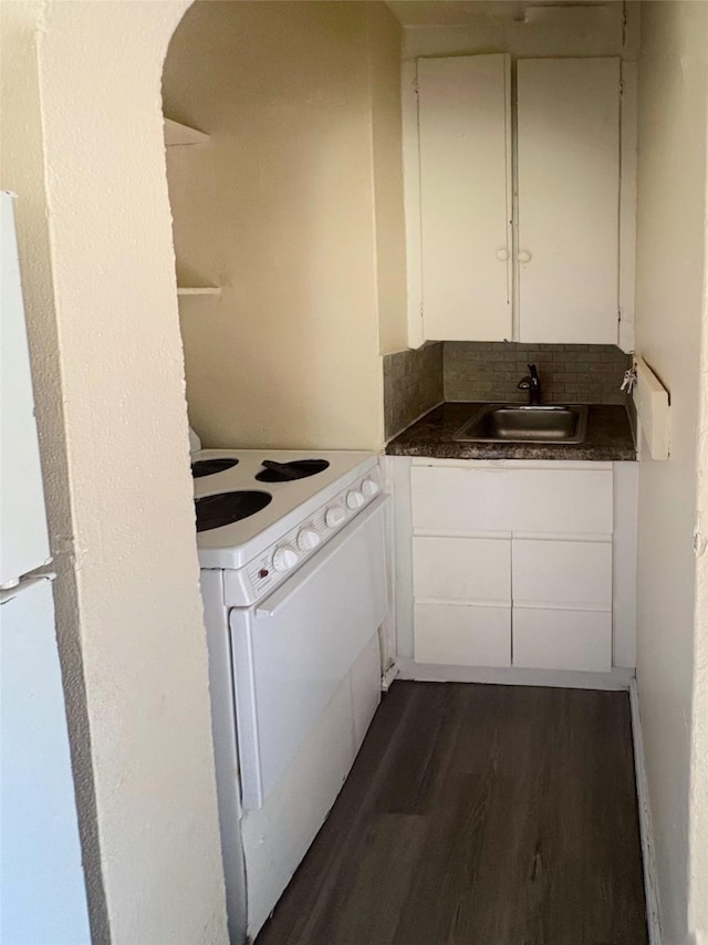 2826 Oxford St, Des Moines, IA 50313 - kitchen featuring electric range, dark wood-type flooring, white cabinetry, dark countertops, and decorative backsplash