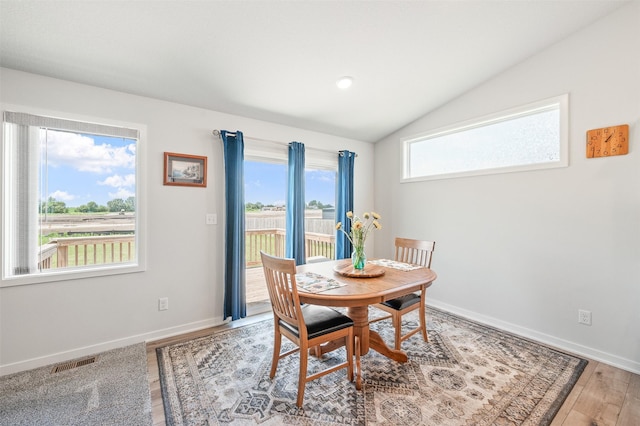 2708 NW Boulder Point Pl, Ankeny, IA 50023 - dining area featuring wood finished floors and vaulted ceiling