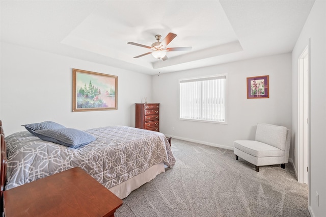 2708 NW Boulder Point Pl, Ankeny, IA 50023 - bedroom with a raised ceiling, carpet flooring, and a ceiling fan