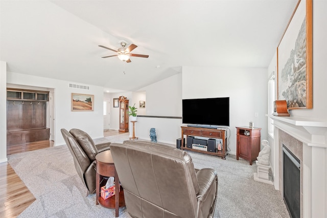 2708 NW Boulder Point Pl, Ankeny, IA 50023 - living area with lofted ceiling, ceiling fan, a fireplace, and light colored carpet