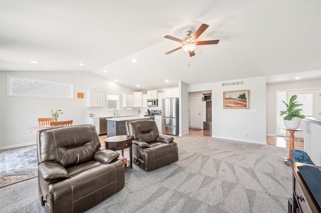 2708 NW Boulder Point Pl, Ankeny, IA 50023 - living area featuring vaulted ceiling, a ceiling fan, light carpet, and recessed lighting