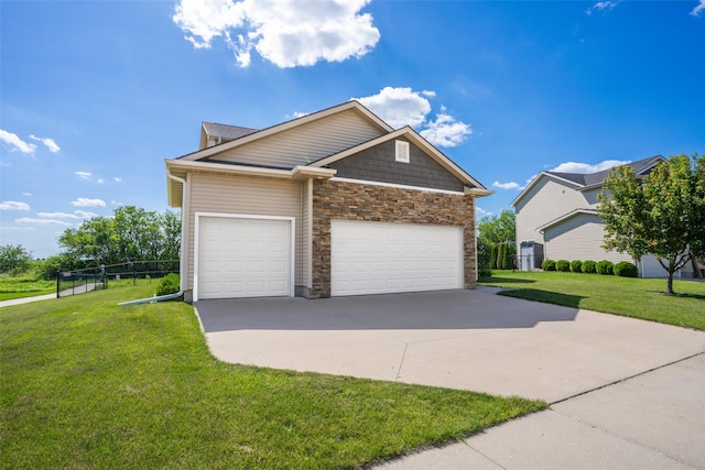 303 SE 14th St, Grimes, IA 50111 - view of front facade featuring stone siding, driveway, and an attached garage