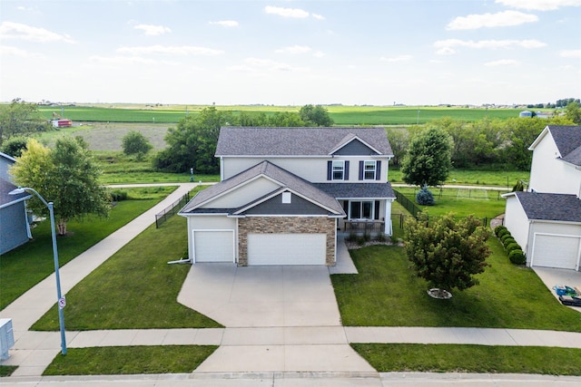 303 SE 14th St, Grimes, IA 50111 - view of front of property featuring stone siding, driveway, a view of countryside, and an attached garage