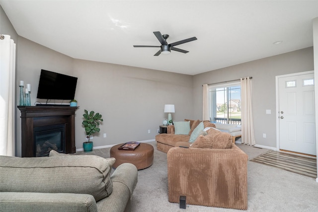 303 SE 14th St, Grimes, IA 50111 - living area featuring carpet flooring, a ceiling fan, and a glass covered fireplace